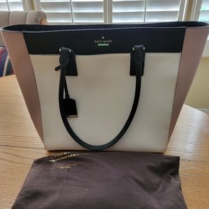 Kate Spade tote. Center zipped pocket. Black and white stripped lining.